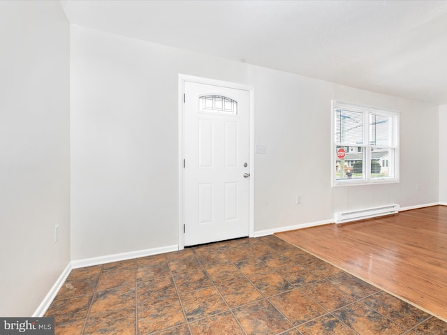 entrance foyer with a baseboard radiator, baseboards, and wood finished floors