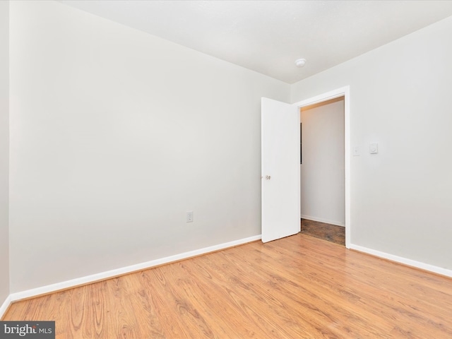 empty room featuring baseboards and wood finished floors