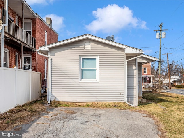 view of side of home featuring fence