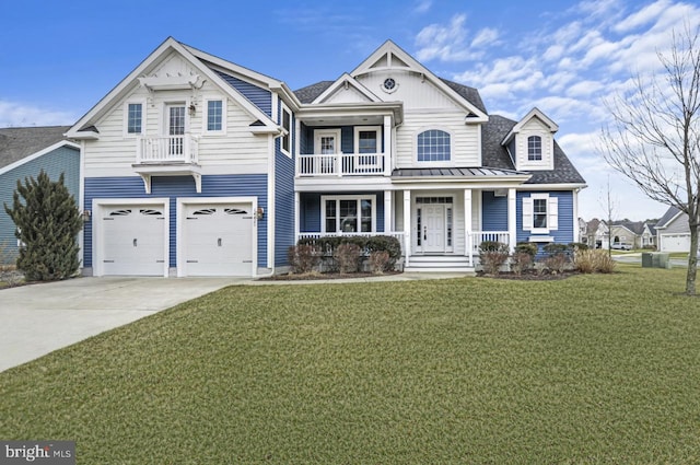 view of front of property featuring driveway, a balcony, a standing seam roof, a porch, and a front yard