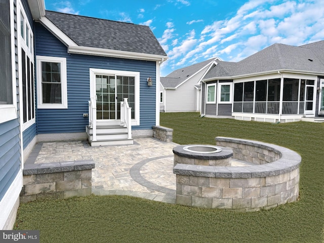 view of patio featuring entry steps, a sunroom, and a fire pit