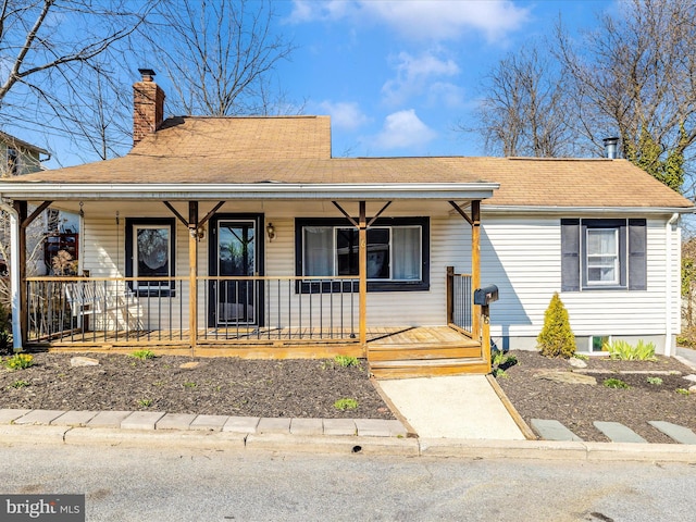 view of front of property with a porch and a chimney