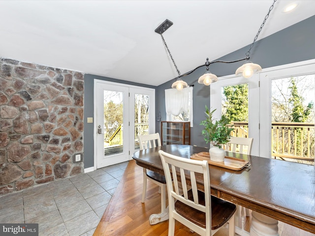 tiled dining space with vaulted ceiling