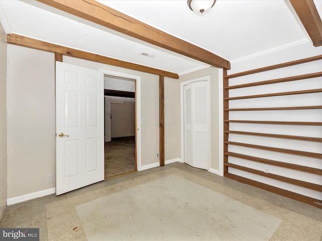 interior space featuring visible vents, crown molding, baseboards, beam ceiling, and tile patterned floors