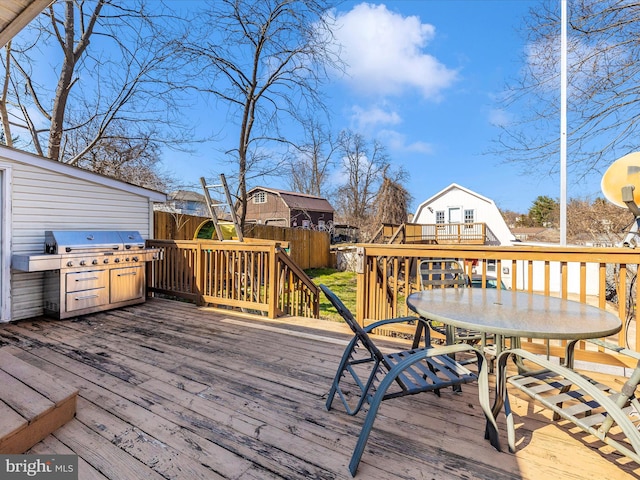 wooden terrace with outdoor dining area and fence