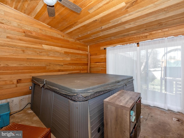 misc room with lofted ceiling, wooden walls, wooden ceiling, and ceiling fan