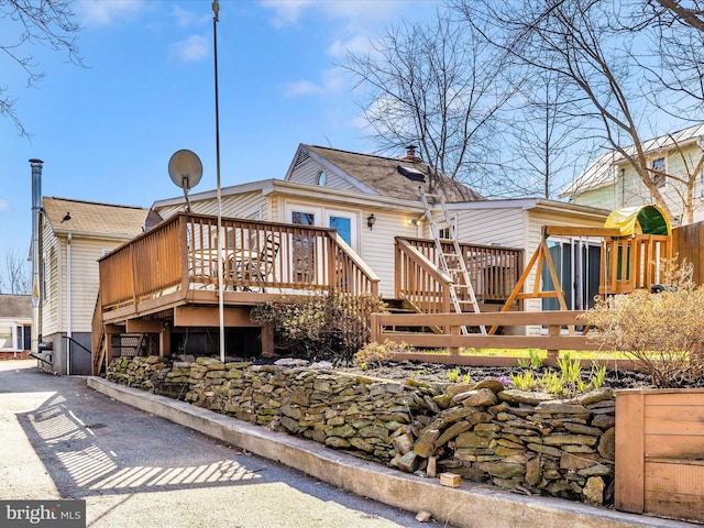 rear view of property featuring a deck