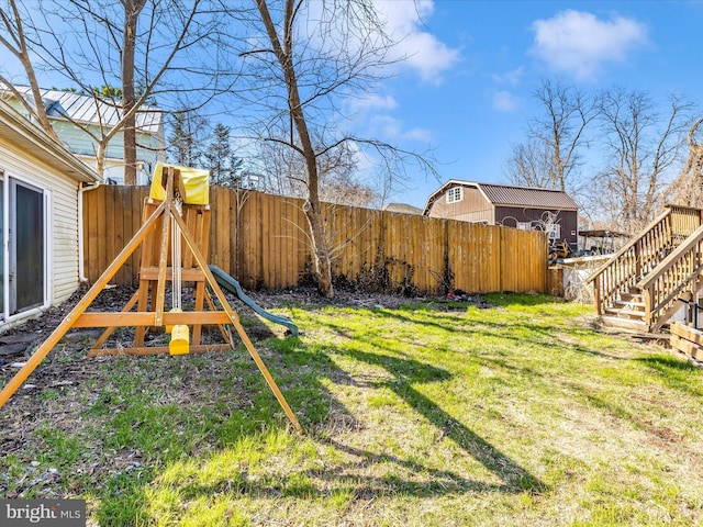 view of yard with a fenced backyard and a playground