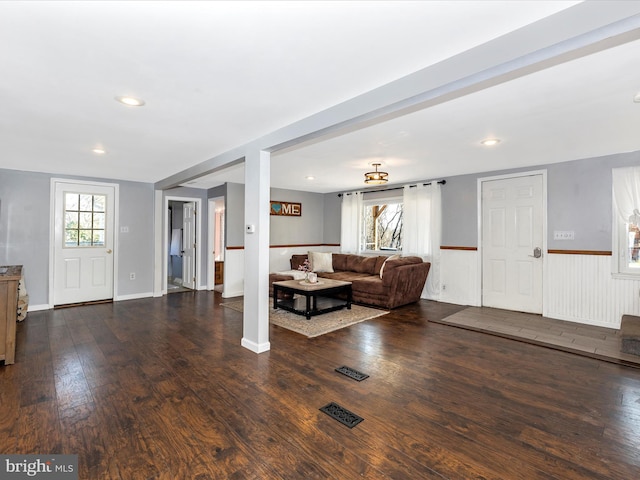 living room featuring dark wood finished floors, recessed lighting, wainscoting, and visible vents