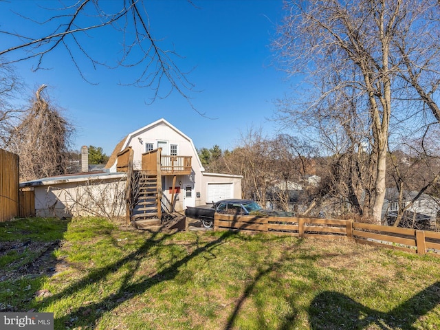 exterior space with a garage, stairs, and fence