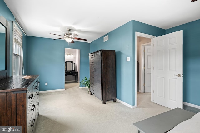 bedroom featuring baseboards, light carpet, visible vents, and a ceiling fan