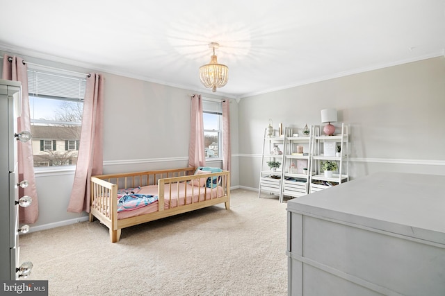 bedroom with crown molding, a notable chandelier, carpet flooring, and baseboards