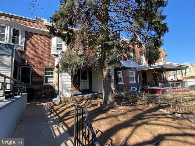 view of property with fence and brick siding