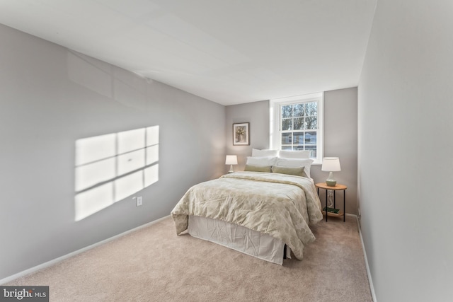 carpeted bedroom featuring baseboards