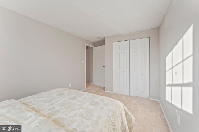 bedroom featuring carpet floors, a closet, and baseboards