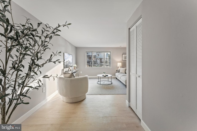 living room with baseboards and light wood finished floors