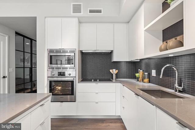 kitchen featuring open shelves, visible vents, appliances with stainless steel finishes, white cabinets, and a sink