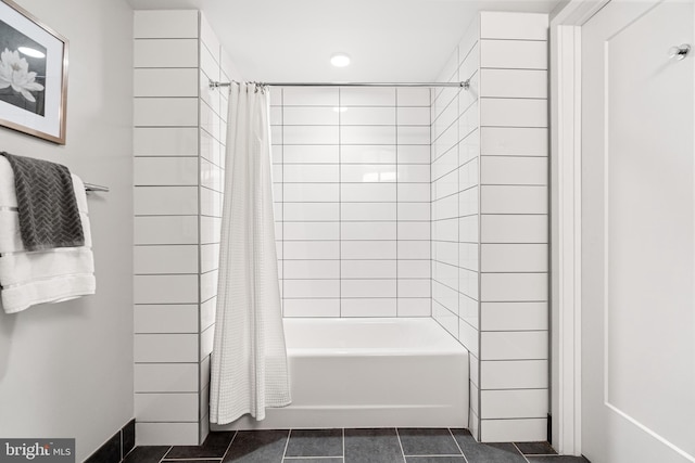 bathroom with shower / bath combo with shower curtain and tile patterned floors