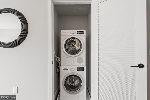 laundry room featuring laundry area and stacked washer and clothes dryer