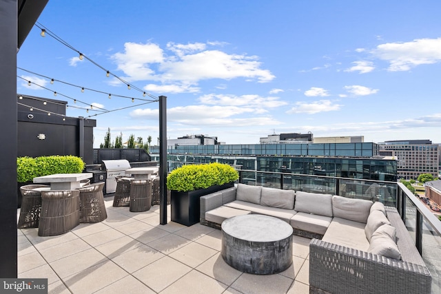 view of patio featuring a balcony, an outdoor kitchen, and an outdoor hangout area