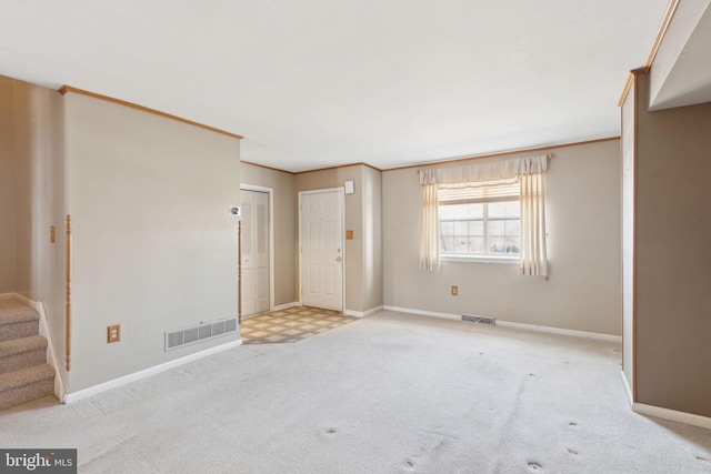 interior space with visible vents, crown molding, stairs, and carpet