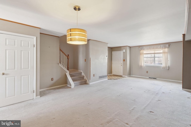 interior space featuring stairs, carpet flooring, baseboards, and visible vents