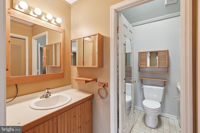 bathroom featuring tile patterned floors, visible vents, toilet, baseboards, and vanity