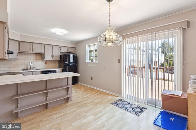 kitchen with black appliances, open shelves, crown molding, light countertops, and decorative backsplash