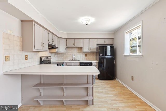 kitchen featuring stainless steel electric range oven, open shelves, freestanding refrigerator, a sink, and under cabinet range hood