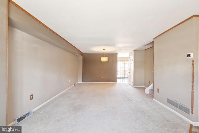 unfurnished room with light carpet, visible vents, and baseboards