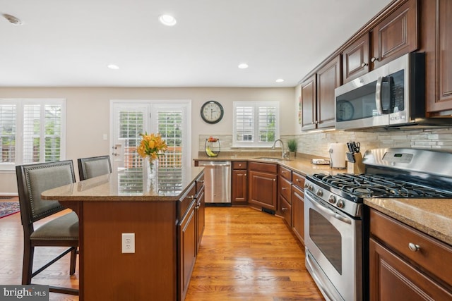 1593 Jason Dr, Cinnaminson, NJ 08077 - kitchen featuring stainless steel appliances, a breakfast bar area, a sink, light stone countertops, and recessed lighting