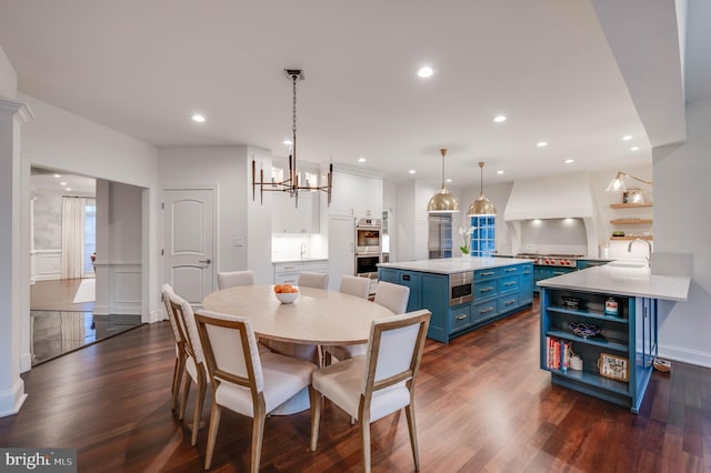 dining area featuring dark wood-type flooring, recessed lighting, and a notable chandelier