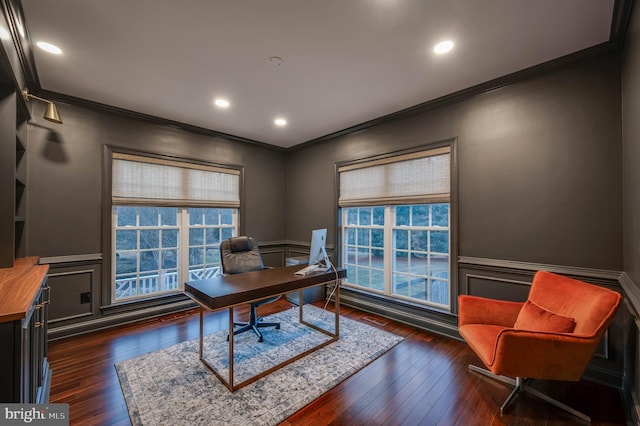 home office with a wainscoted wall, dark wood-type flooring, and a healthy amount of sunlight