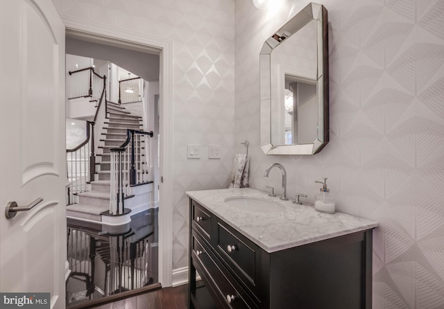 bathroom with wood finished floors and vanity