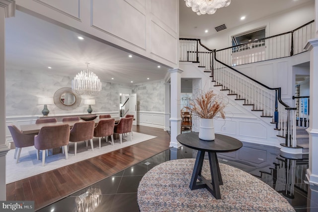 interior space featuring visible vents, stairway, a decorative wall, a notable chandelier, and recessed lighting