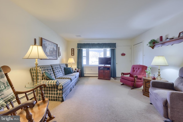 living room with visible vents, baseboard heating, and light colored carpet