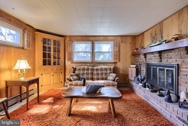 living area featuring a brick fireplace, plenty of natural light, and wood walls