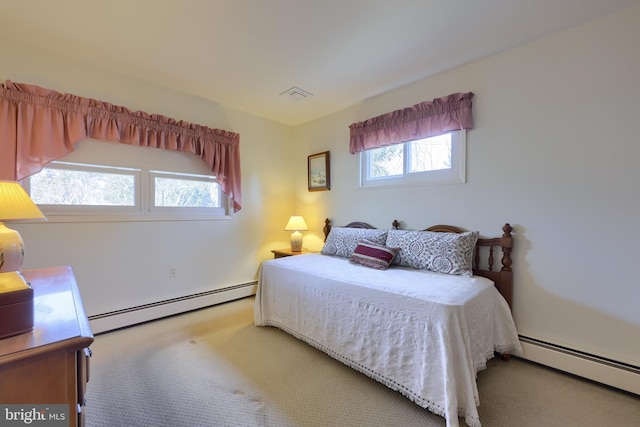 carpeted bedroom with a baseboard radiator and visible vents