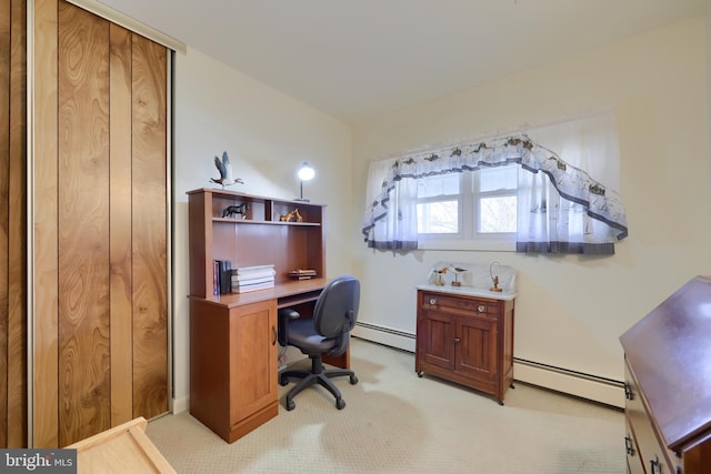 home office with a baseboard radiator and light colored carpet