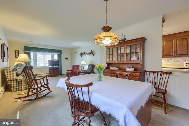 dining space featuring light carpet, visible vents, and baseboard heating