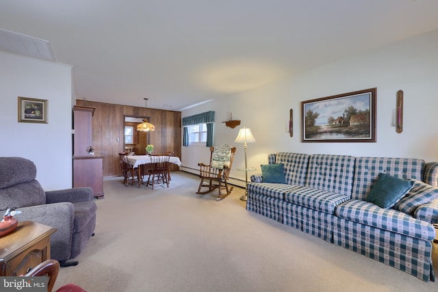 carpeted living area featuring wood walls and baseboard heating