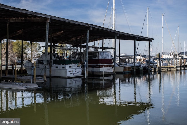 dock area with a water view and boat lift