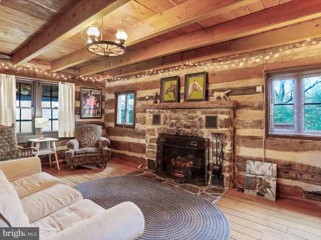 living room featuring hardwood / wood-style floors, beamed ceiling, an inviting chandelier, and wood ceiling