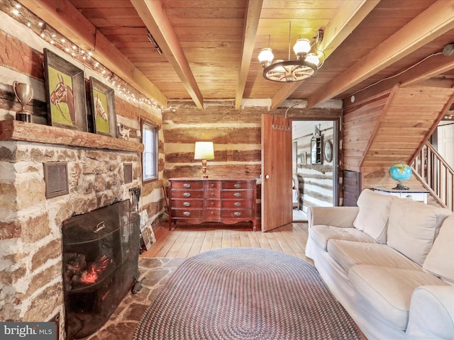 living room featuring a chandelier, beamed ceiling, wooden walls, hardwood / wood-style flooring, and wooden ceiling