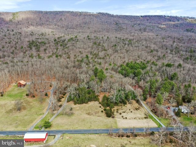 birds eye view of property with a view of trees