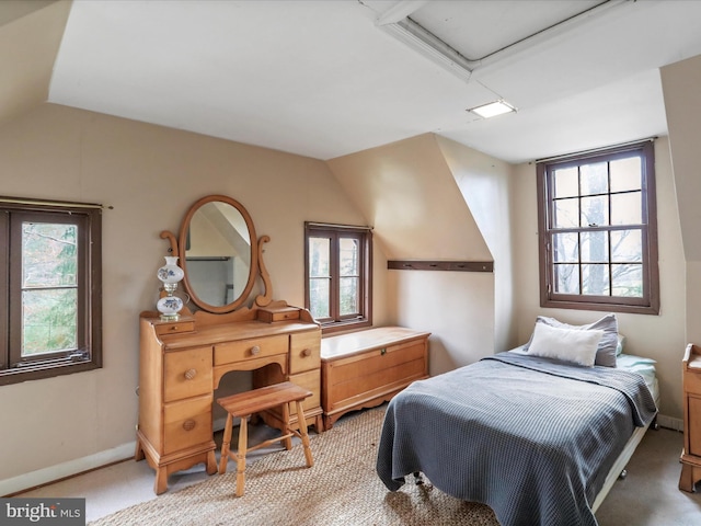 bedroom with light carpet, baseboards, and vaulted ceiling