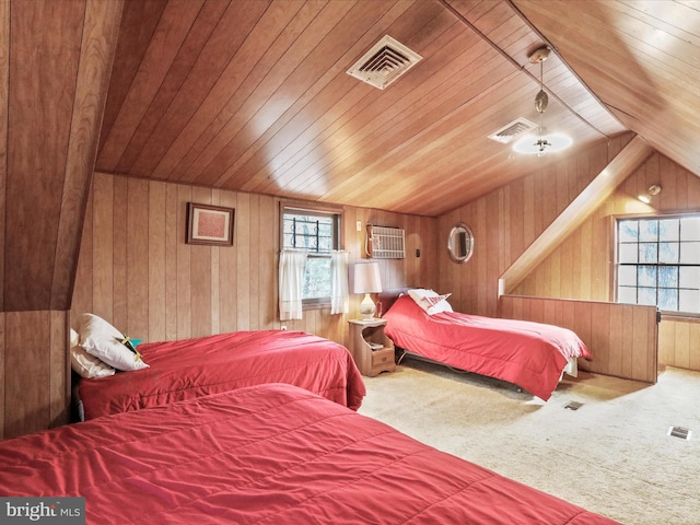 carpeted bedroom featuring visible vents, wooden ceiling, and wood walls