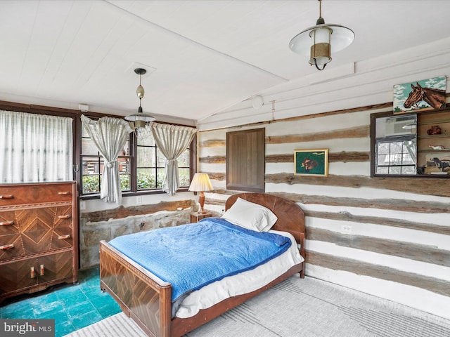 bedroom featuring wood walls and vaulted ceiling