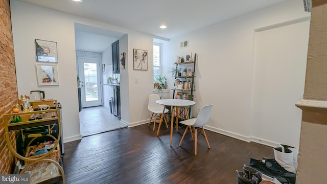 dining space with recessed lighting, wood finished floors, visible vents, and baseboards