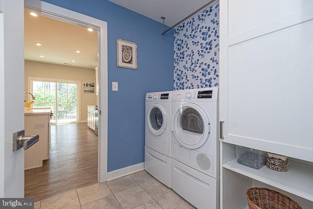 washroom featuring recessed lighting, washing machine and dryer, light tile patterned flooring, laundry area, and baseboards